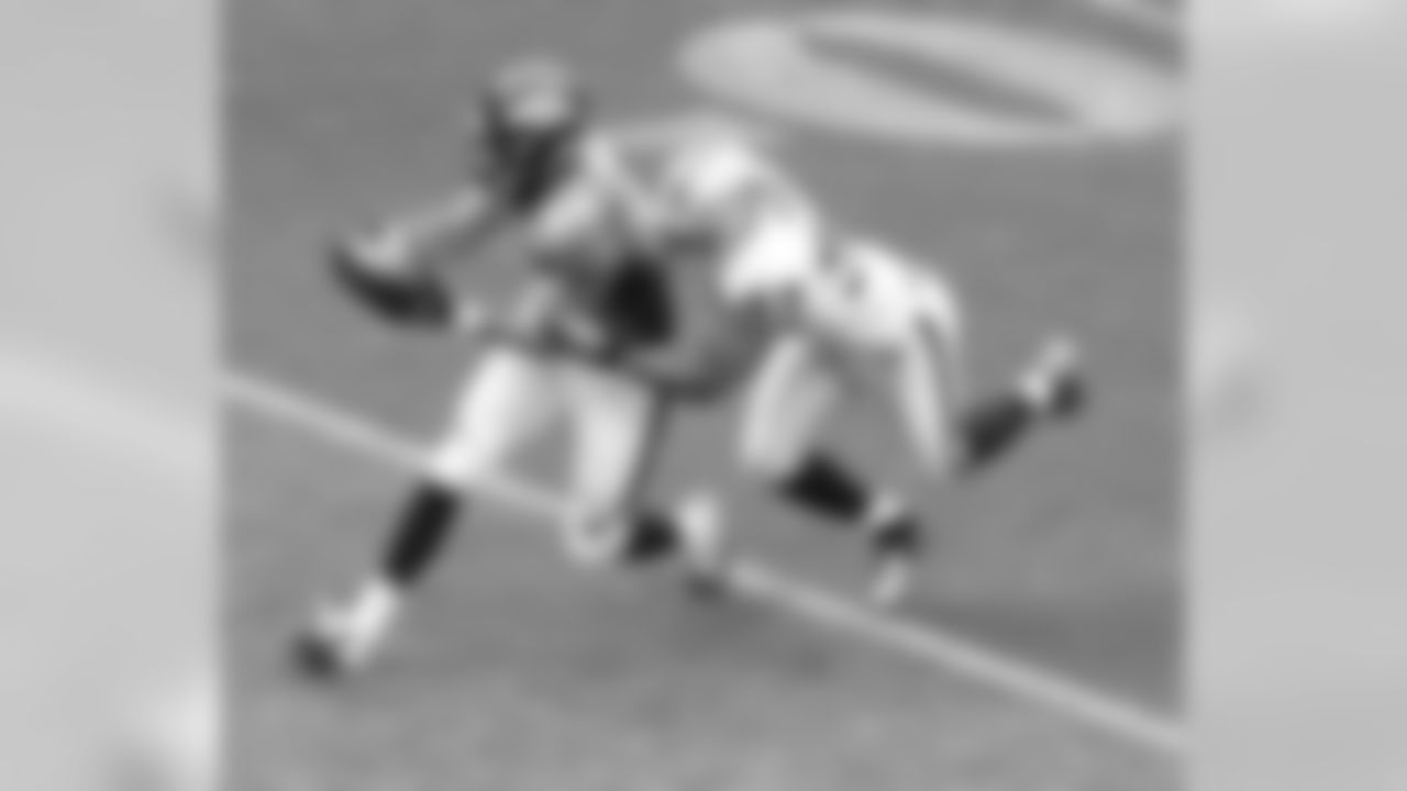 TE Jacob Tamme drags a Raiders defender forward for extra yards.
