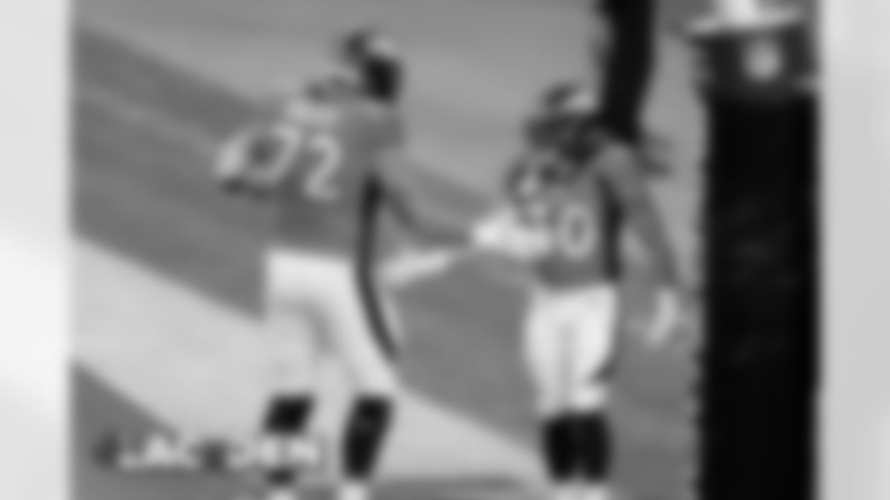 Phillip Lindsay celebrates with Garett Bolles after running for a touchdown during the second half of the Broncos' Week 8 game against the Los Angeles Chargers at Empower Field at Mile High on November 1, 2020. (Photo by Gabriel Christus)