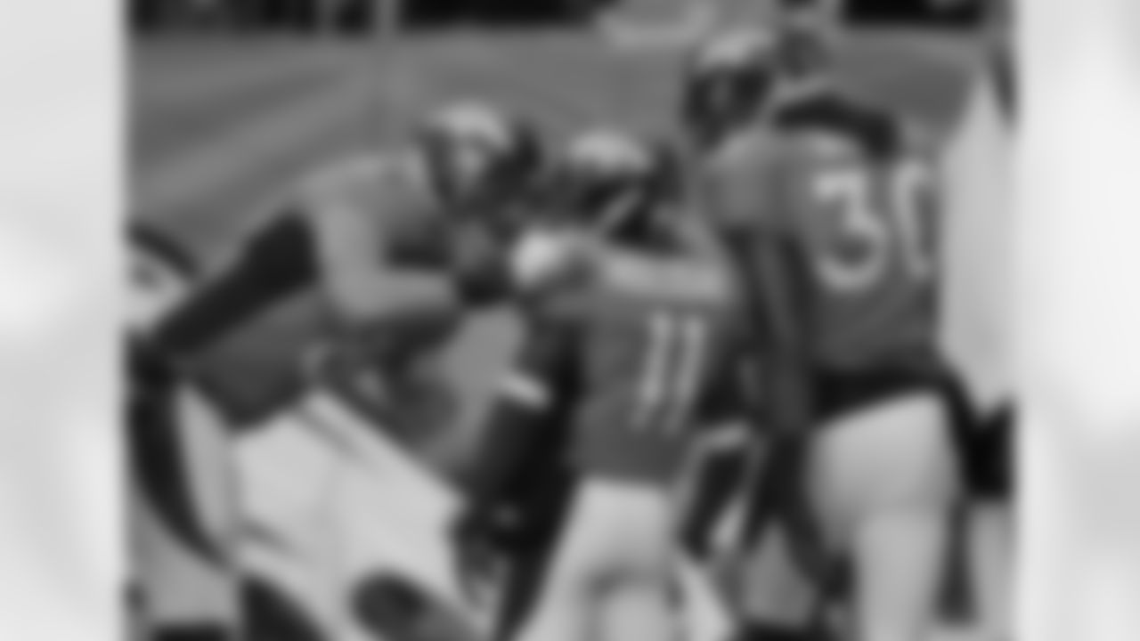 The Broncos celebrate Holliday's second return score of the game.