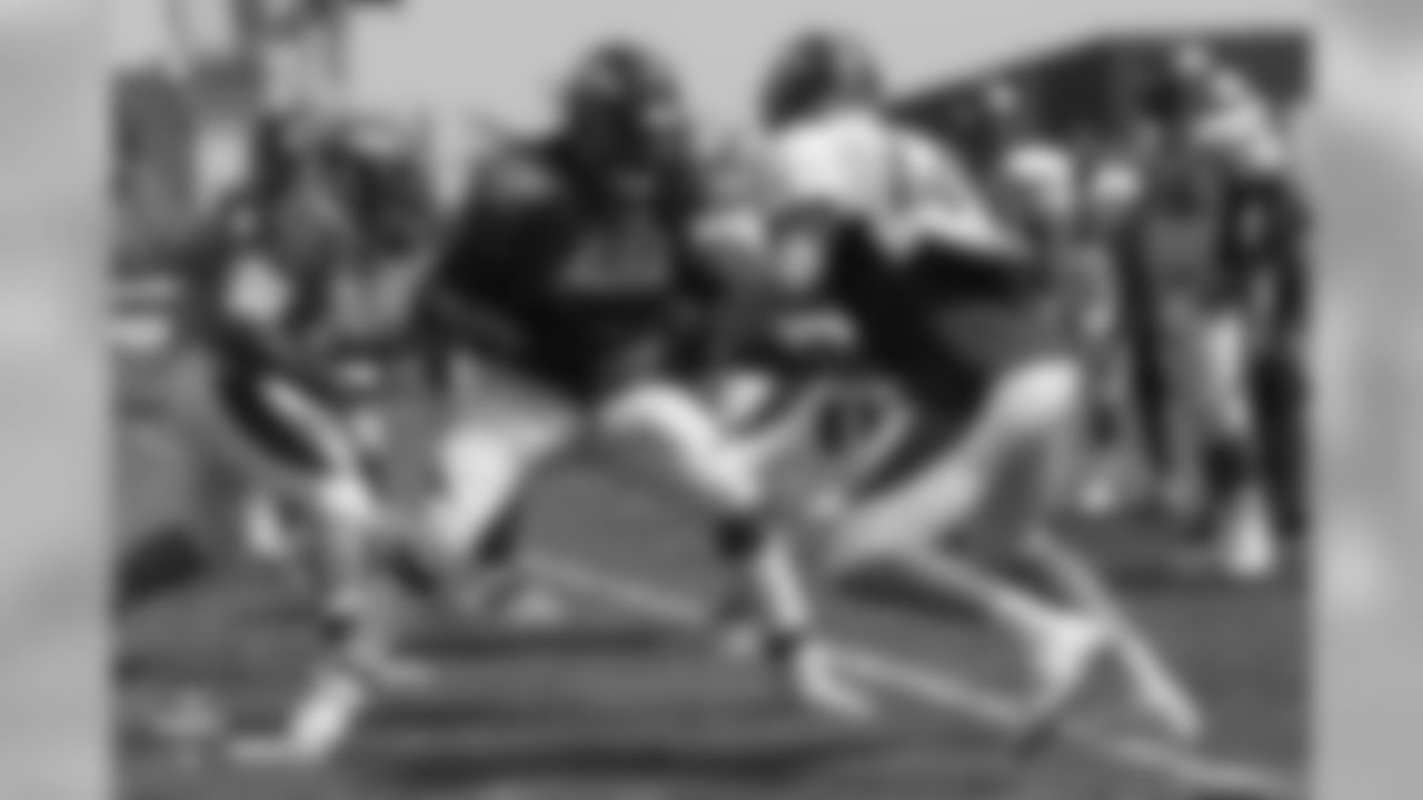 Tackle Leon Johnson (63) blocks against linebacker Marcus Rush (49) during the ninth day of training camp on August 7, 2018, at UCHealth Training Center.