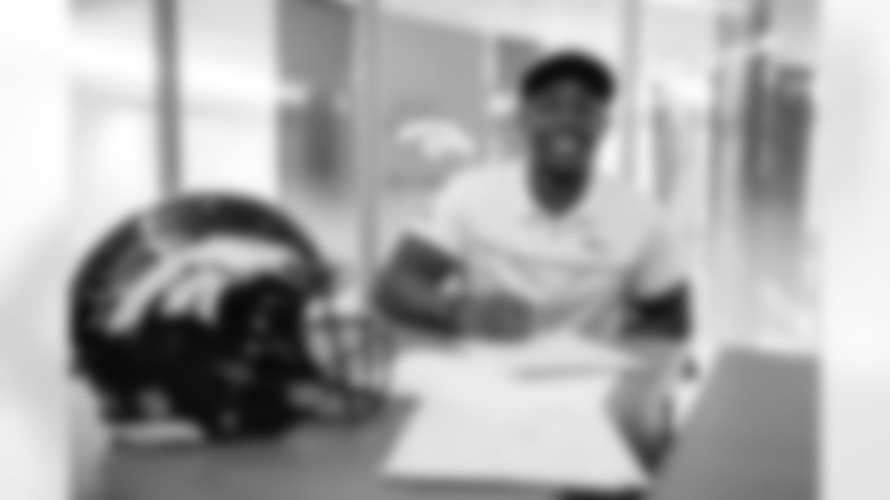 Free-agent addition Mike Boone signs his contract during his visit to UCHealth Training Center on March 18, 2021. (Photo by Joe Abdellah)