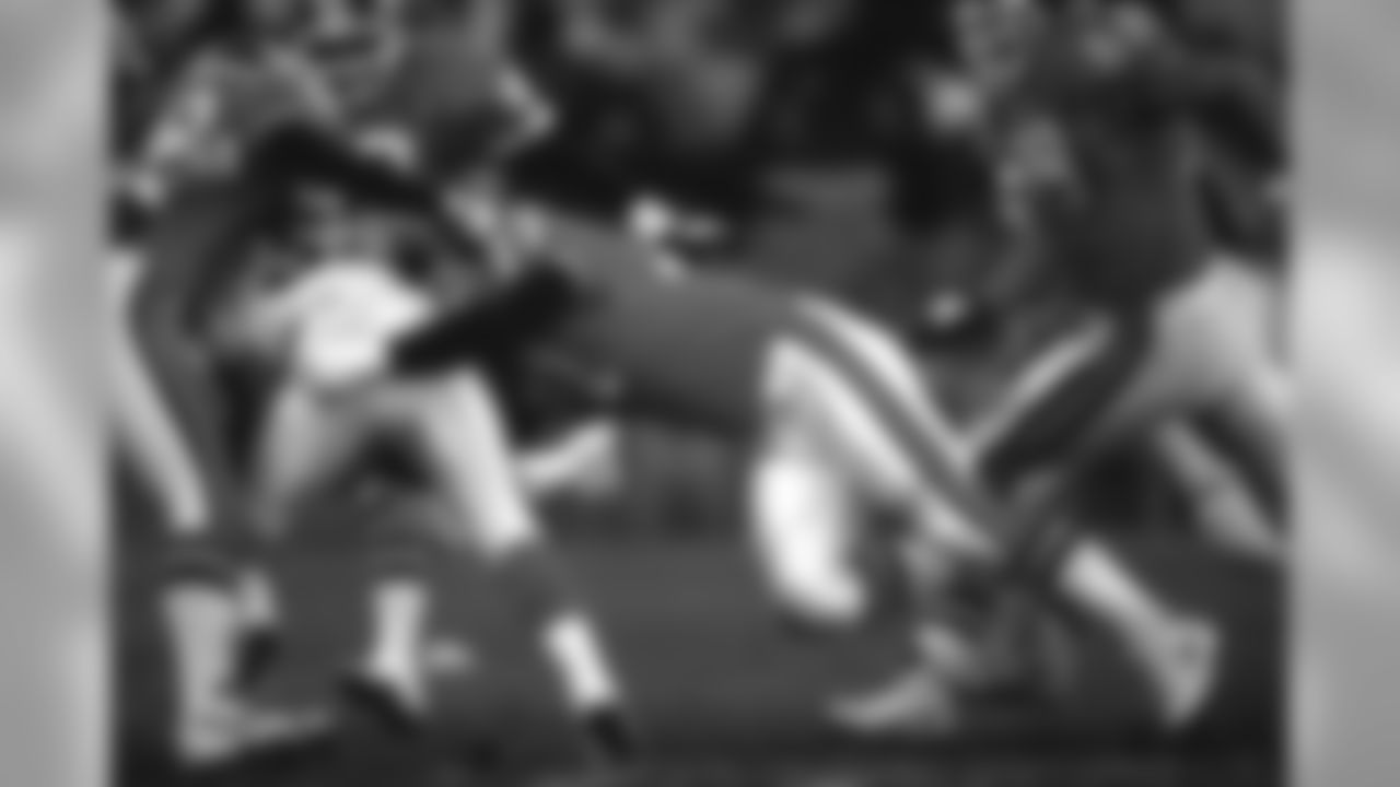 Linebacker Karl Mecklenburg and other members of the Broncos defense nail a Bengals ballcarrier during a November 27, 1994 win (15-13) over Cincinnati at Mile High Stadium.