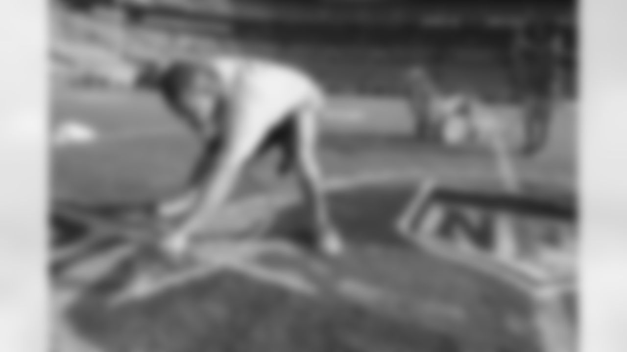 The grounds crew gets the field ready for Saturday's Divsional Round game.