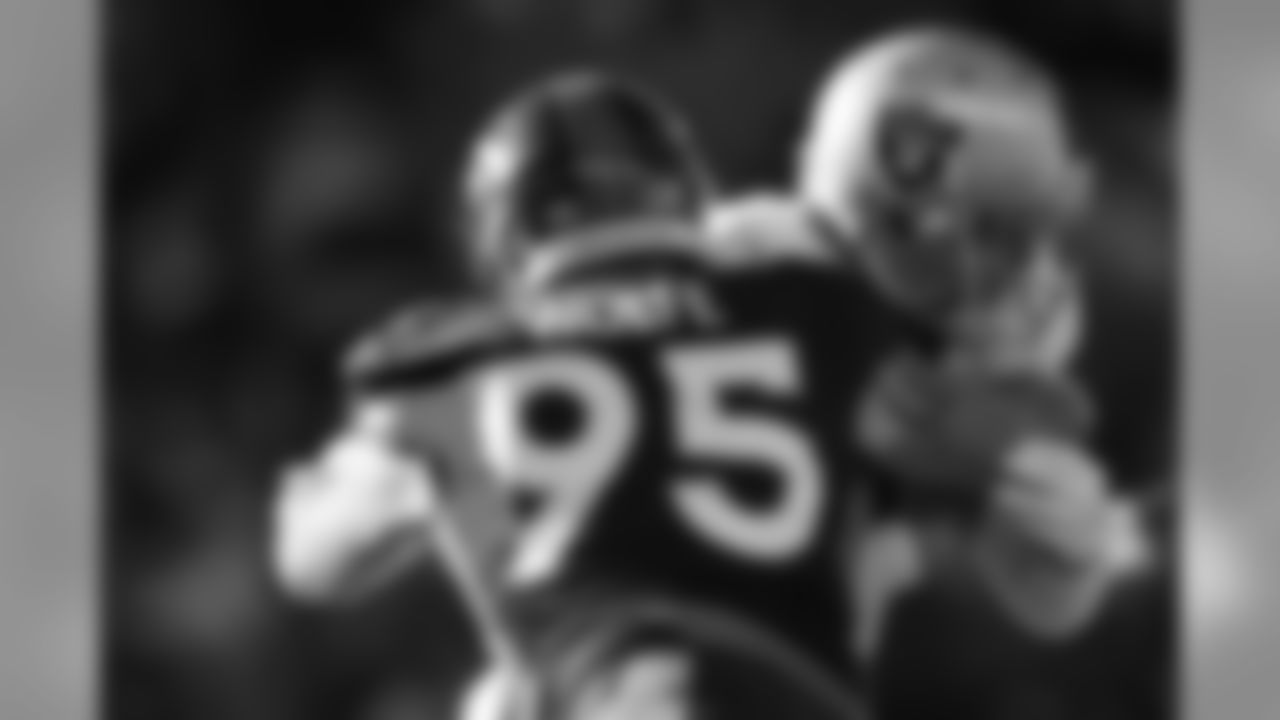 Denver Broncos defensive end Derek Wolfe (95) sacks Oakland Raiders quarterback Derek Carr (4) during second quarter action against the Oakland Raiders during the game at Sports Authority Field at Mile High in Denver, CO, December 13, 2015.
Photo by Gabriel Christus