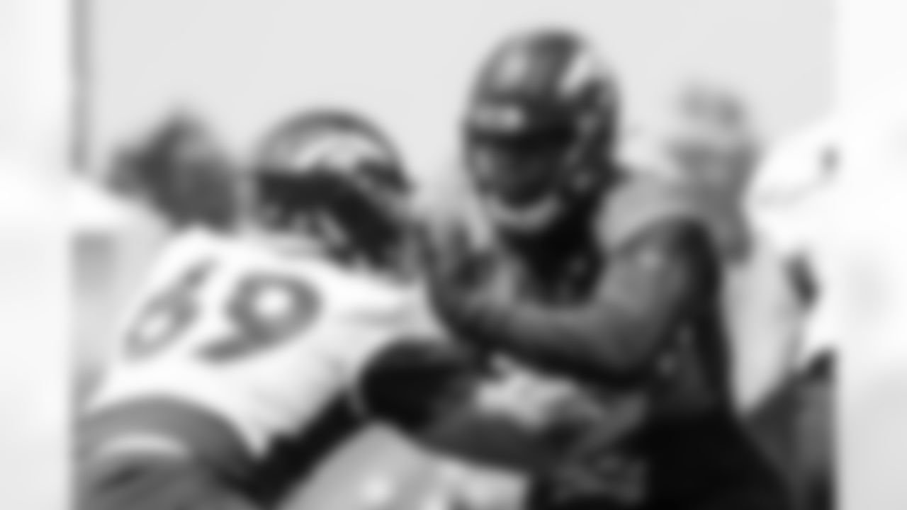 Nolan Laufenberg and Marquiss Spencer during a training camp practice for early reports (rookies, quarterbacks and select veterans) at UCHealth Training Center on July 25, 2021. (Photo by Ben Swanson)