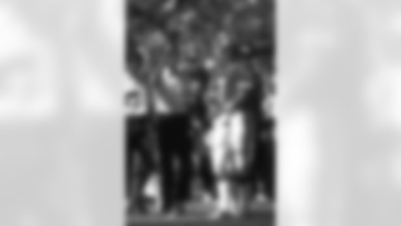 John Elway stands on the sidelines with Dan Reeves.