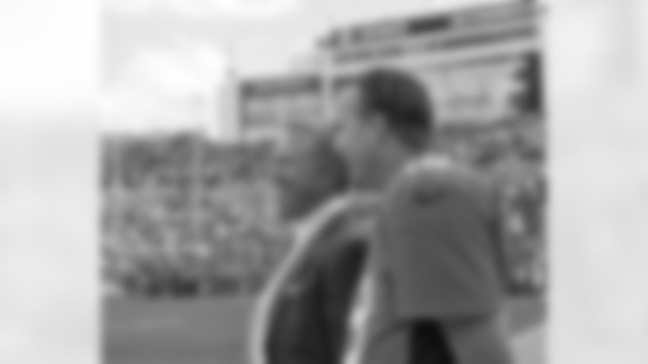 In the closing minutes, Denver Broncos Executive Vice President of Football Operations John Elway and Peyton Manning enjoy the team's win 37-6 over the Oakland Raiders on September 30, 2012. In joining the Broncos, Manning followed Elway a the next league-wide star quarterback to play in orange and blue.