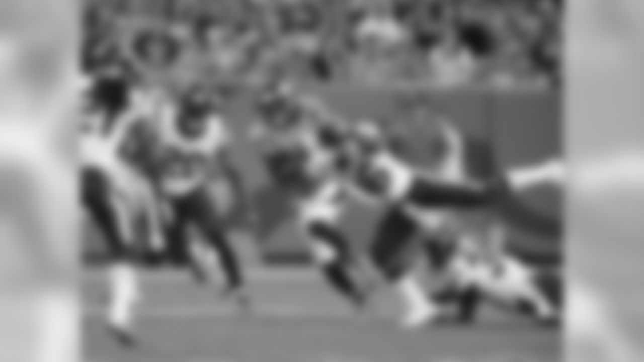 Denver Broncos wide receiver Emmanuel Sanders (10) fights for yards as Texans defender close in on him.