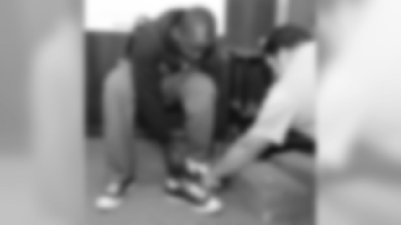 Ball tries on a pair of shoes.