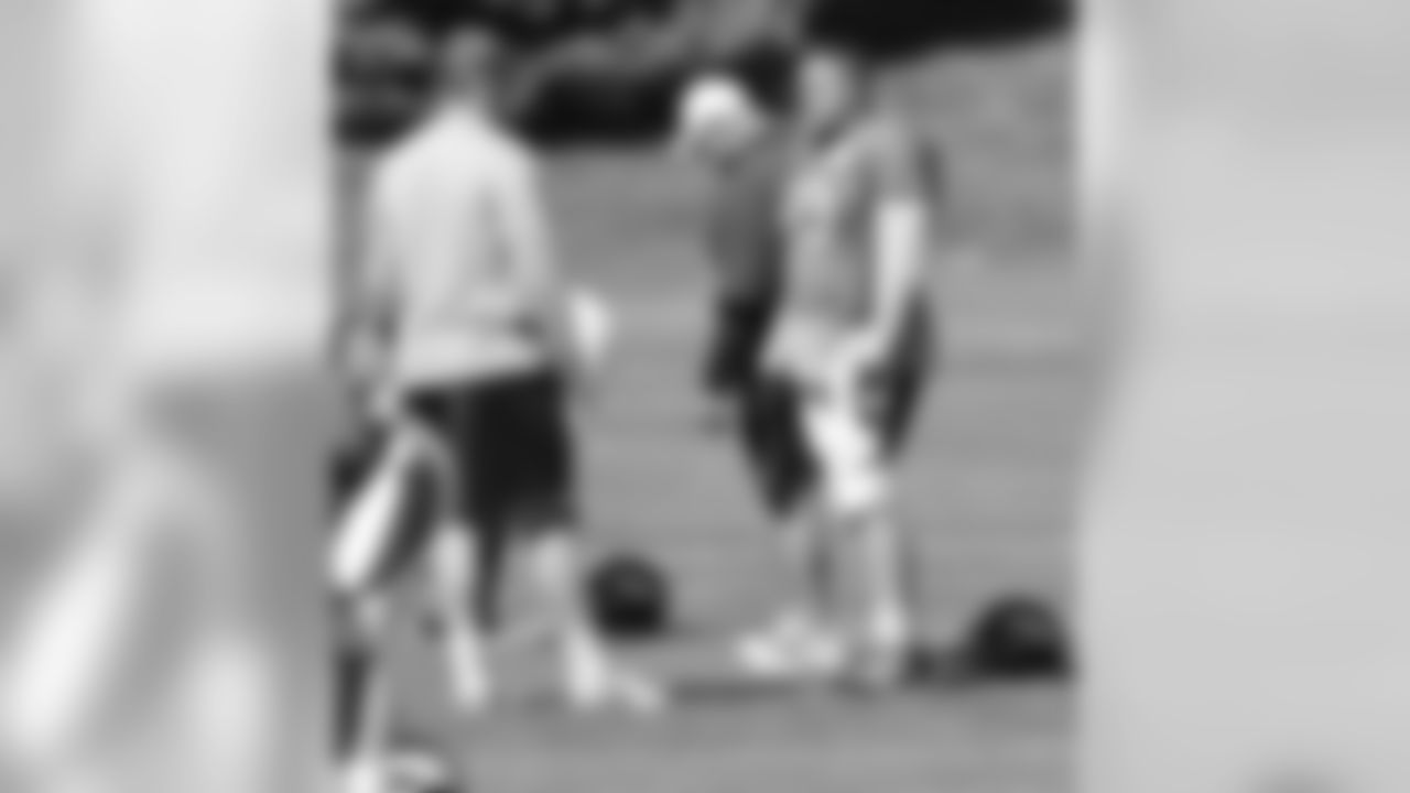 G Chris Kuper talks with C J.D. Walton during stretching.