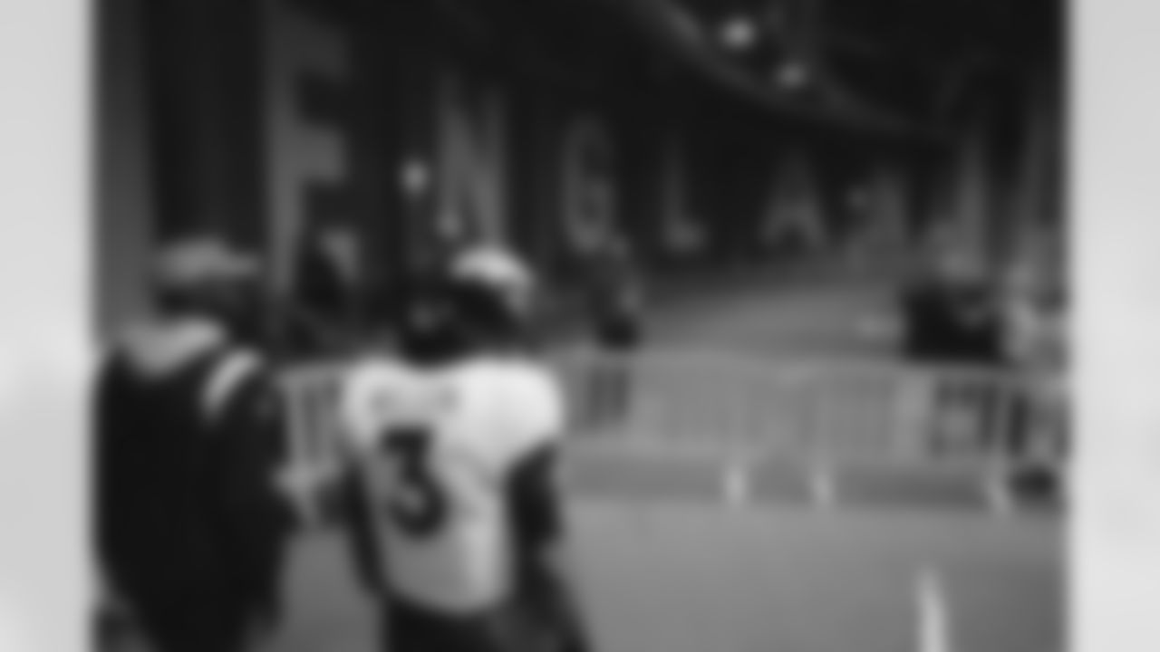 Russell Wilson walks through the tunnel in front of the ENGLAND sign during the Broncos' Week 8 game against the Jaguars at Wembley Stadium in London on October 30, 2022. This image is part of the Broncos' film series documenting the team's trip to London. (Photo by Ben Swanson)