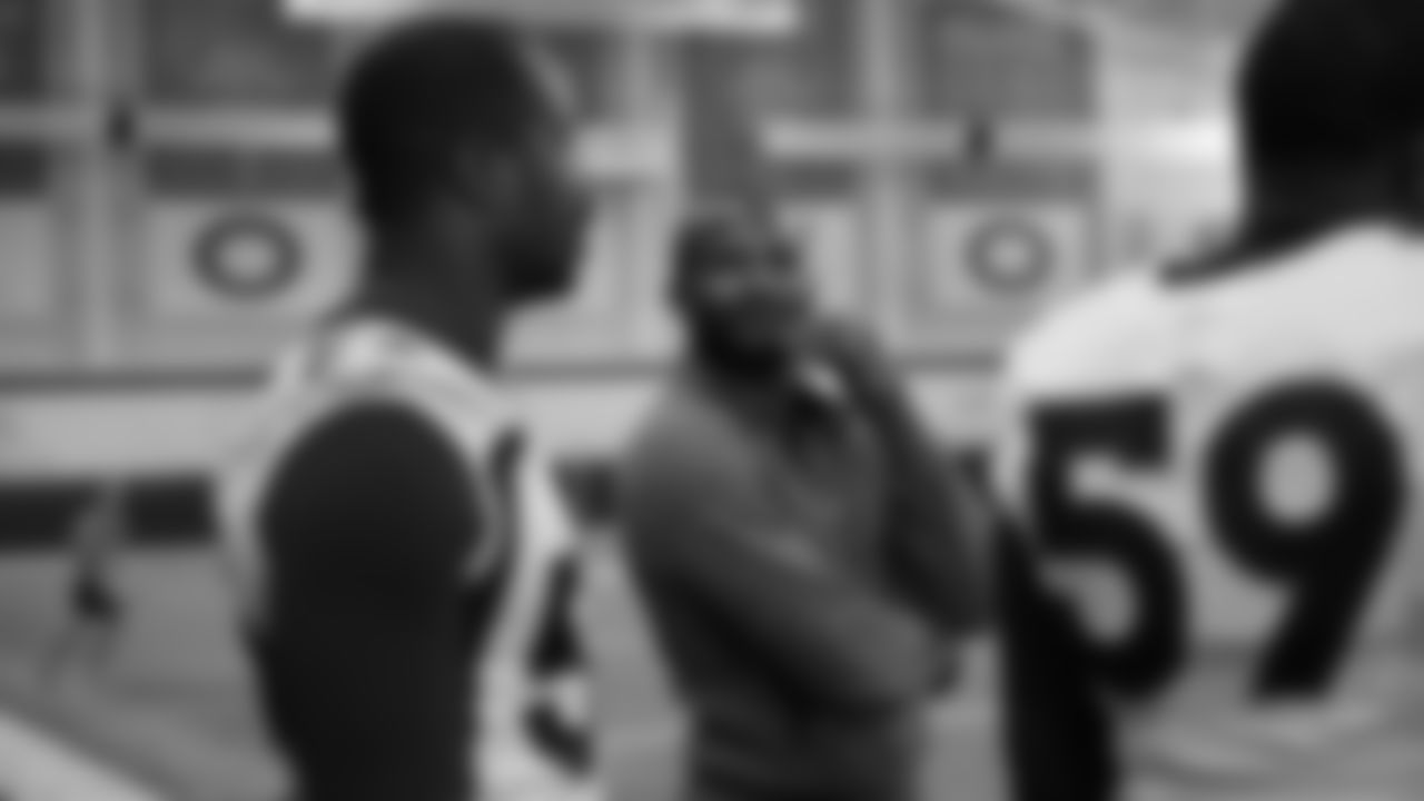 Pro Football Hall of Fame and Broncos Ring of Fame cornerback Champ Bailey talks with Von Miller and Malik Reed at practice on October 11, 2019 at UCHealth Training Center. (Photo by Ben Swanson)
