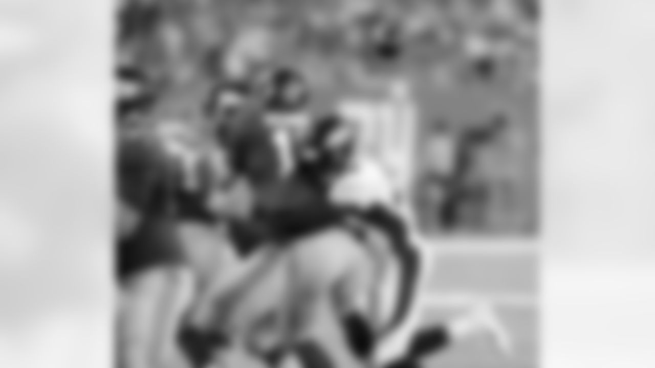 Mike Adams hits Eli Manning as he releases a pass.