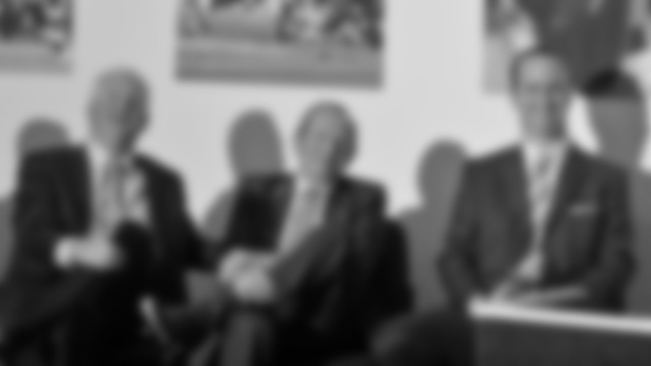 Denver Broncos quarterback Peyton Manning, right, listens along with team owner Pat Bowlen, center, and Head Coach John Fox, left, to remarks by Executive Vice President of Football Operations John Elway during a news conference March 20, 2012.