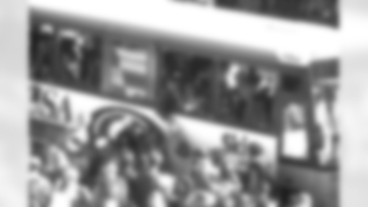 Denver: An estimated 650,000 fans turned out along 17th Street, Broadway and Civic Center Park to cheer on the Broncos during their Championship Parade, the day after returning from the Super Bowl. Here, offensive coordinator Gary Kubiak signs autographs for fans from a bus.
