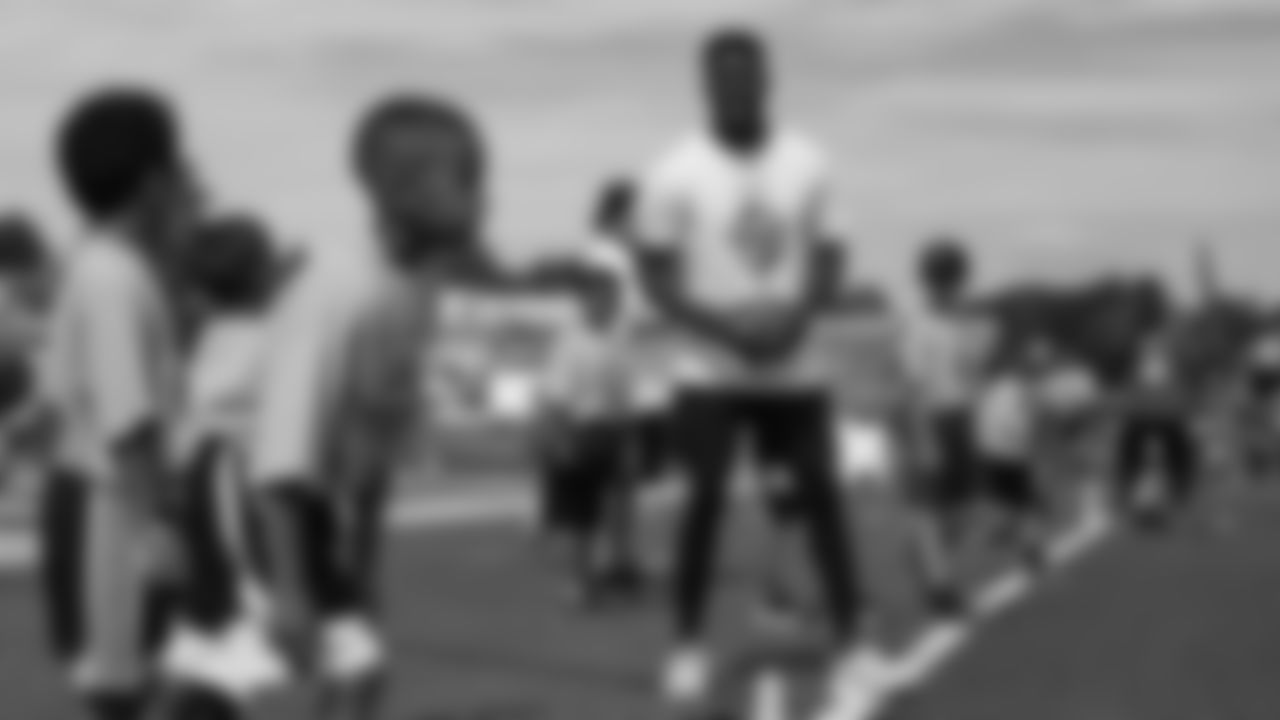 Emmanuel Sanders interacts with children at his youth football camp at Thomas Jefferson High School in Denver on July 1, 2019.