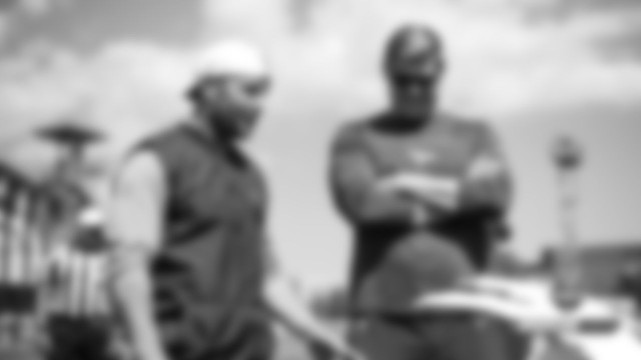 Assistant Offensive Line Coach Chris Kuper talks with former teammate Wes Welker, who is now the 49ers' wide receivers coach, at a joint practice with the San Francisco 49ers on the 19th day of training camp on August 16, 2019.