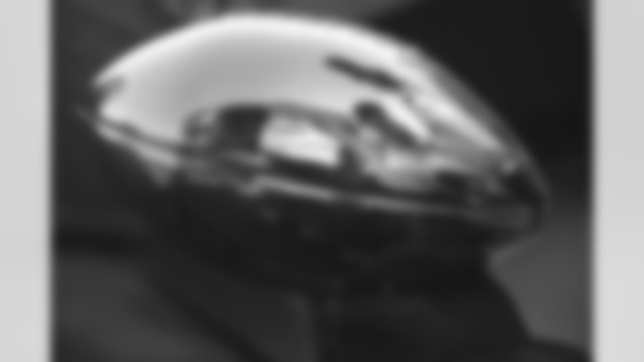 An estimated 350,000 fans turned out in downtown Denver and then on to City Hall to catch a glimpse of their back-to-back World Champion Broncos. Here, Terrell Davis' face is reflected in the Lombardi Trophy.