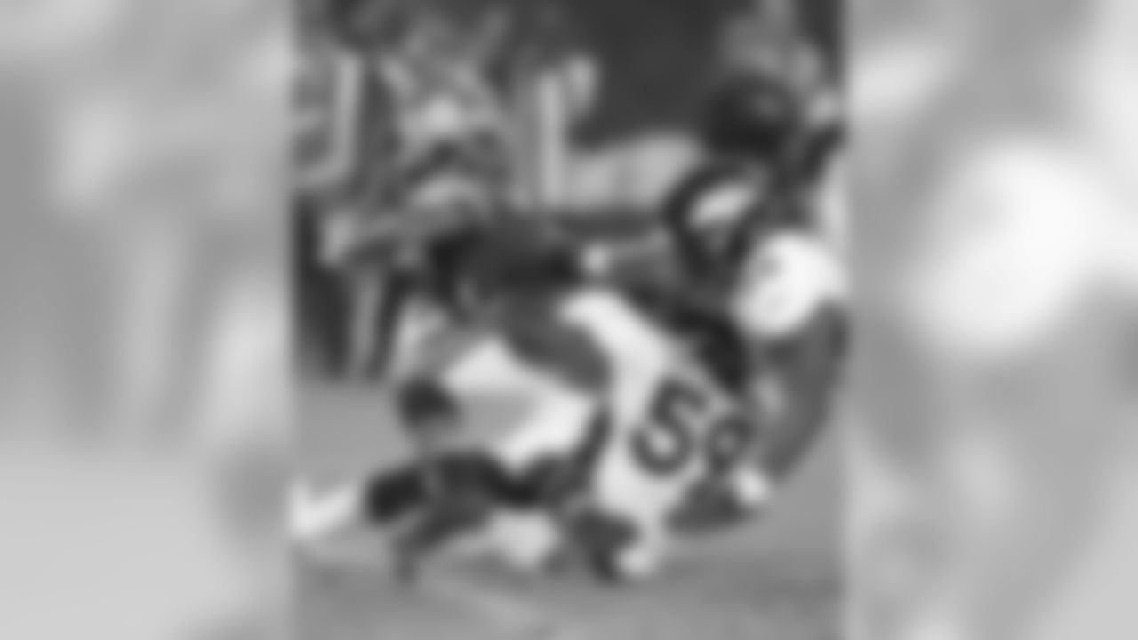 A pair of young linebackers make a tackle.
