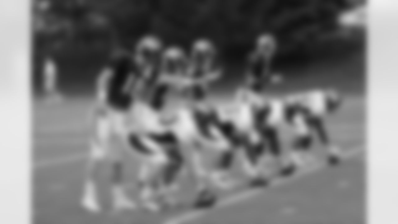 The quarterbacks work on pre-snap signals.