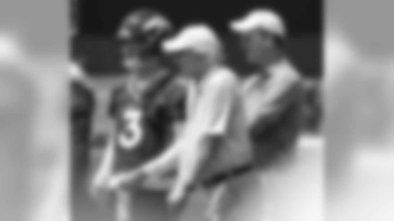 Peyton and Archie Manning talk with Drew Lock, who attended the Manning Passing Academy, during the Broncos' second mandatory minicamp practice on June 5, 2019.