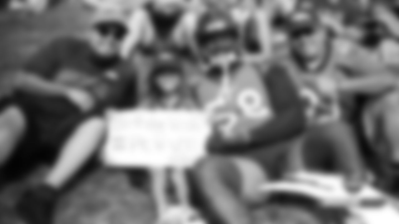 Von Miller poses for a photo with a young fan on her birthday during practice on Day 11 of training camp on July 30, 2019.