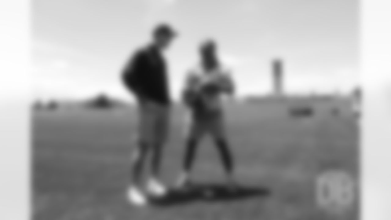 Will Parks talks with former Broncos quarterback Peyton Manning after the Broncos' practice on the eight day of their OTAs on May 30, 2019.