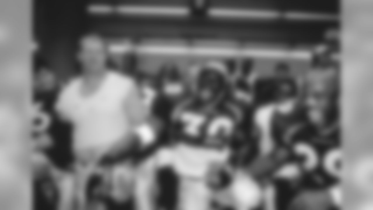 Terrell Davis celebrates after receiving the game ball against the Cincinnati Bengals at Mile High Stadium in Denver, CO on September 21, 1997.