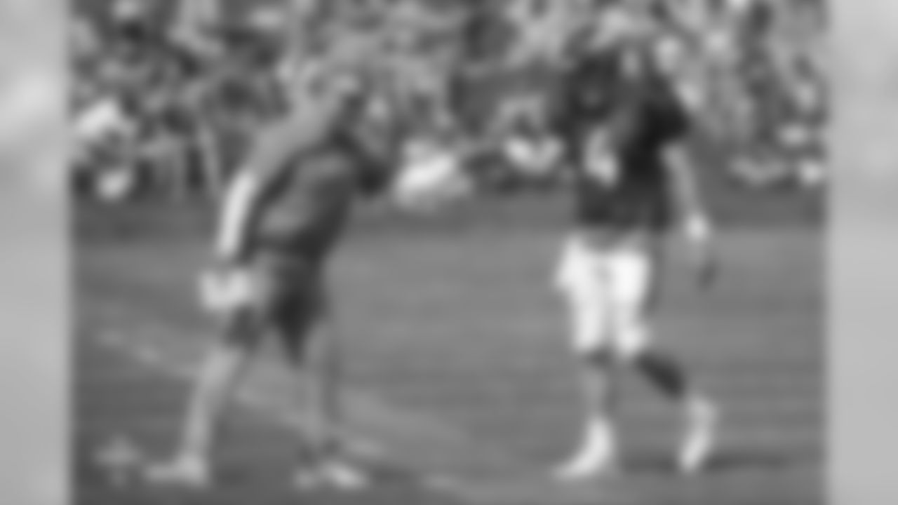 Quarterback Case Keenum (4) and Quarterbacks Coach Mike Sullivan fist bump during the ninth day of training camp on August 7, 2018, at UCHealth Training Center.
