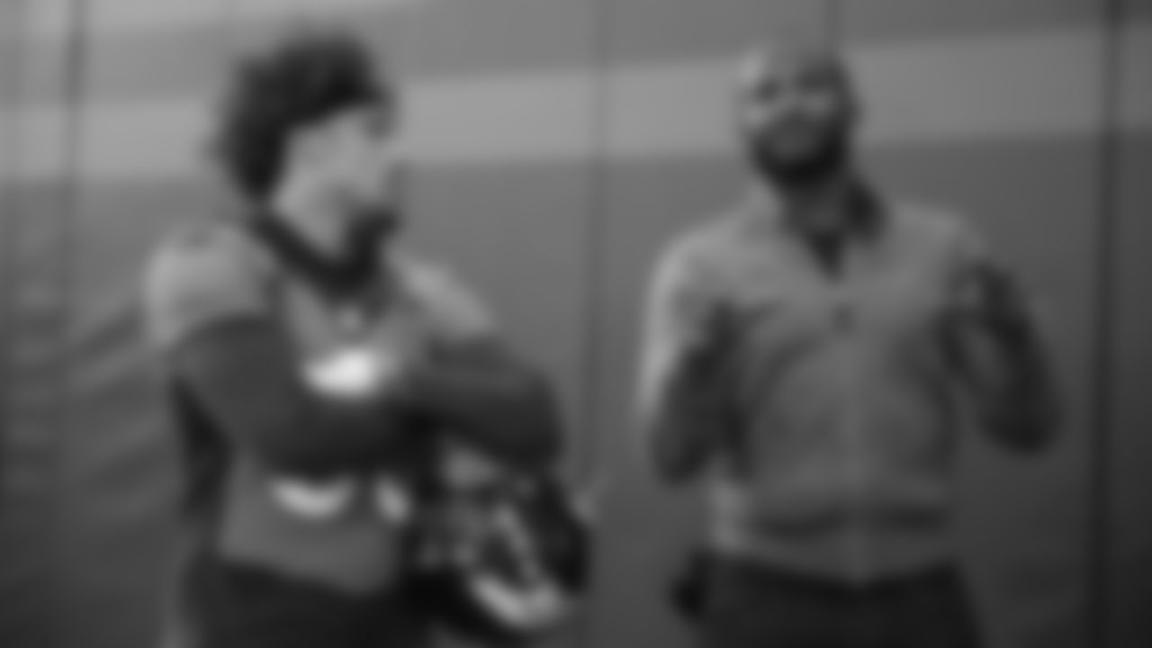 Phillip Lindsay talks with Pro Football Hall of Fame and Broncos Ring of Fame cornerback Champ Bailey at practice on October 11, 2019 at UCHealth Training Center. (Photo by Ben Swanson)