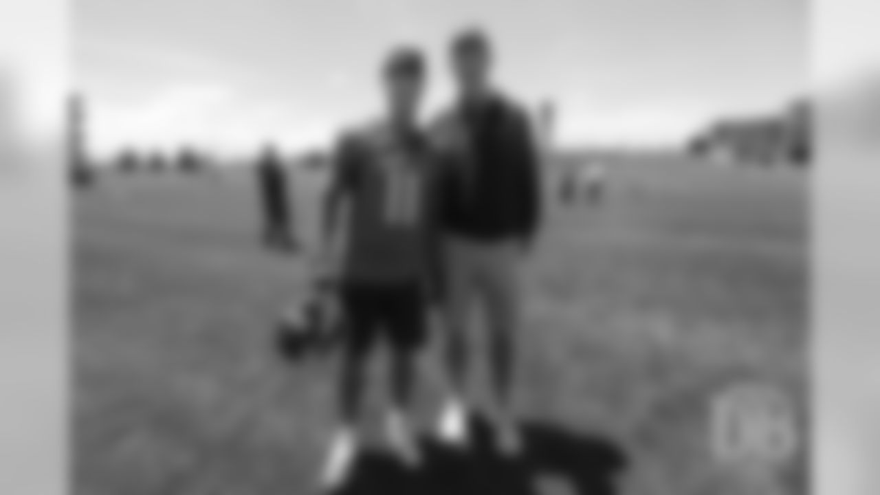 River Cracraft poses for a photo with former Broncos quarterback Peyton Manning after the Broncos' practice on the eight day of their OTAs on May 30, 2019.