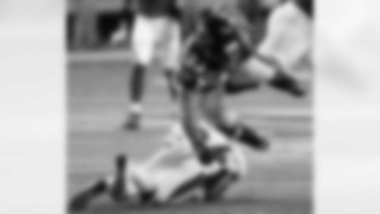 S Rahim Moore upends Atlanta running back Michael Turner.