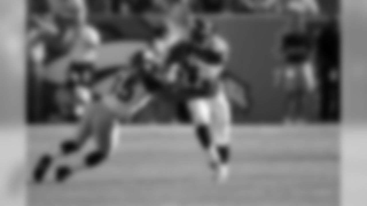 Olandis Gary (1999 - fourth round, 127th overall) breaks a tackle against the Rams on Sept. 8, 2002.