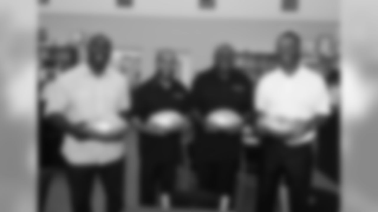 In this photo released by the NFL, former NFL football players Terrell Davis, Saladin Martin, Wally Henry and Marcus Allen visit Lincoln High School in San Diego Tuesday, June 2, 2015. To celebrate the 50th Super Bowl, players who played in any Super Bowl received commemorative footballs to give to their high school alma maters. (Denis Poroy / AP Images for National Football League)