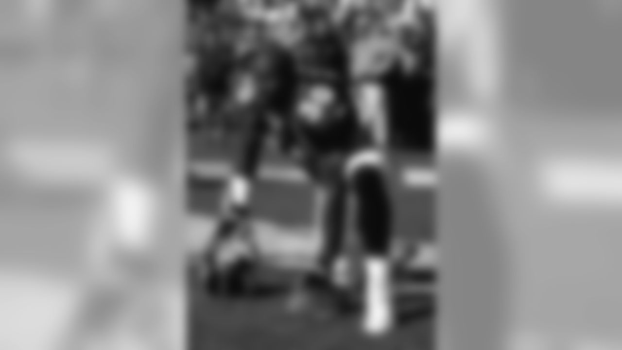 Terrell Davis stretches during pregame warmups before a game against the Jacksonville Jaguars at Mile High Stadium in Denver, CO on October 25, 1998.