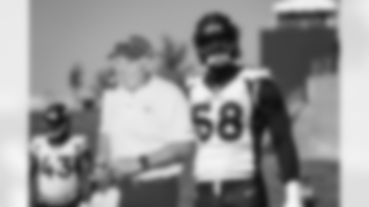 Von Miller poses for a photo with Fred Fleming before the fifth training camp practice at UCHealth Training Center on August 19, 2020. Fleming, usually a constant presence at training camp, has been absent this year due to COVID-19 precautions. (Photo by Ben Swanson)