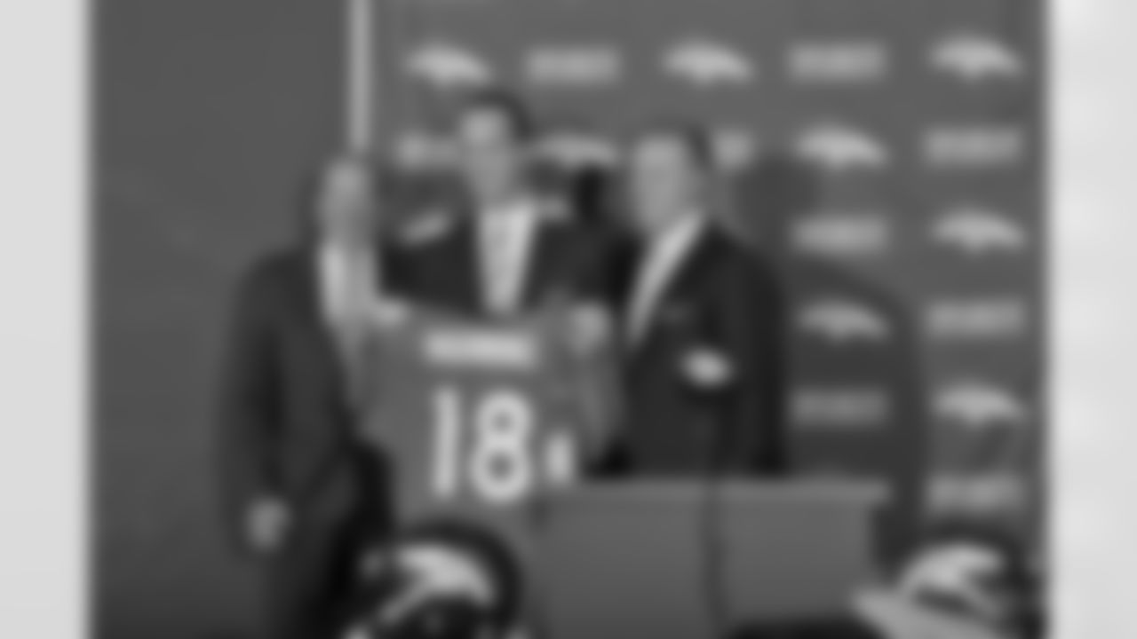 Denver Broncos owner Pat Bowlen,left, and Executive Vice President of Football Operations John Elway,right, pose with Peyton Manning as he shows off his newsl jersey during a press conference at the Dove Valley facility March 20, 2012.