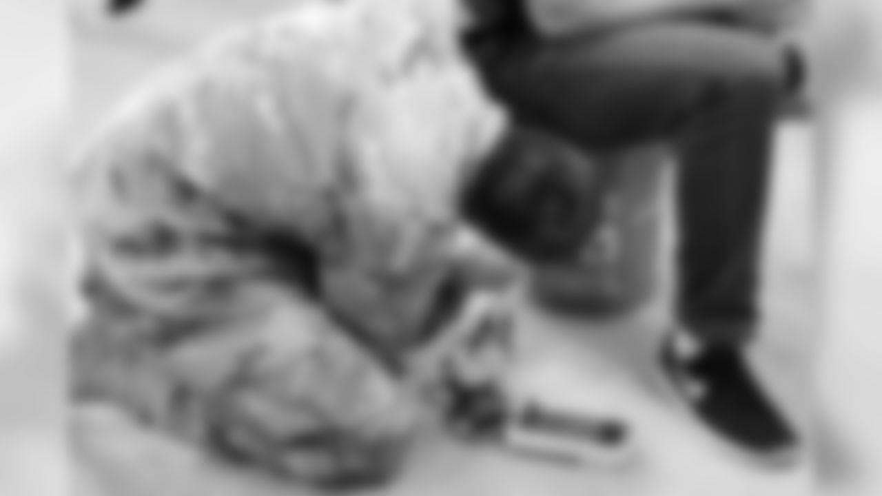 A member of the the 71st EOD Company shows how to defuse a 'bomb' with a citizen on top of it.
