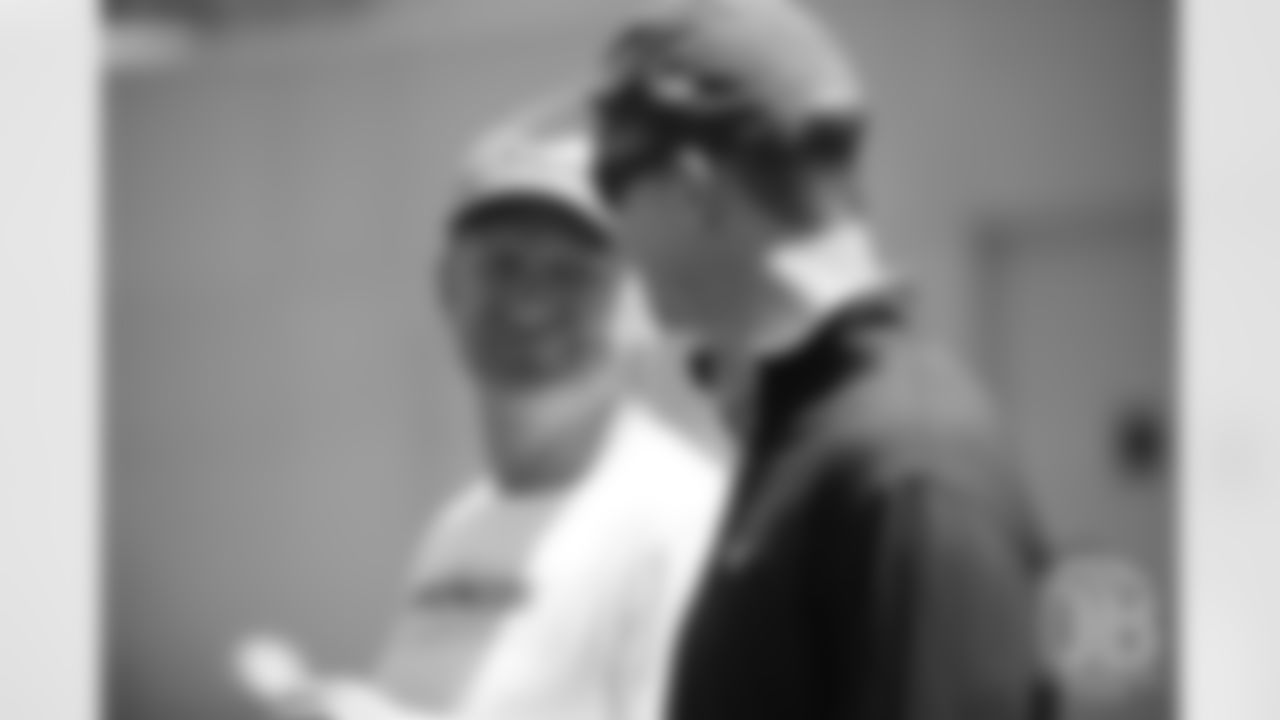 Director of Player Personnel Matt Russell talks with former Broncos quarterback Peyton Manning during the Broncos' practice on the eight day of their OTAs on May 30, 2019.
