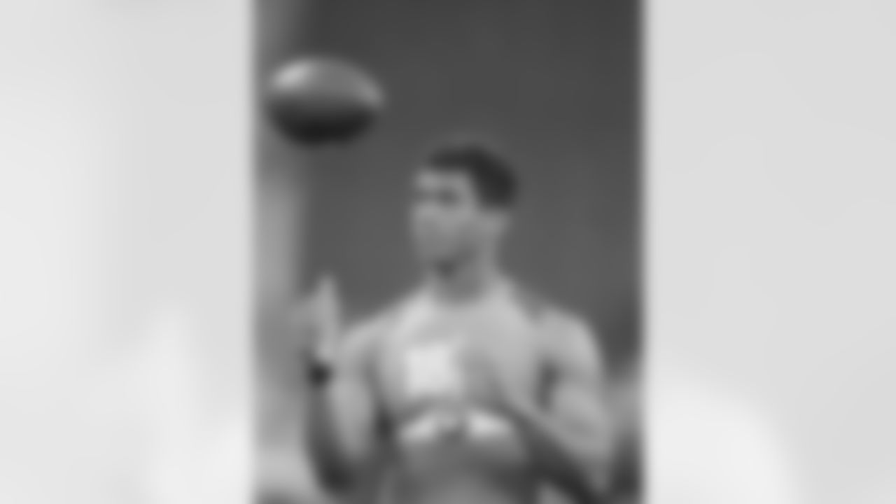 Wisconsin quarterback Russell Wilson throws as he runs a drill at the NFL football scouting combine in Indianapolis, Sunday, Feb. 26, 2012. (AP Photo/Michael Conroy)
