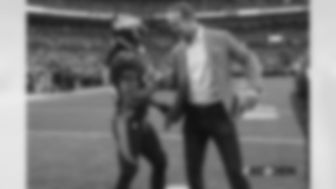 Adam Jones greets Peyton Manning during pregame warmups before the game against the Kansas City Chiefs at Broncos Stadium at Mile High on October 1, 2018.