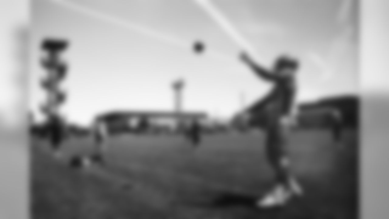Aqib Talib and Von Miller play catch on the sideline during practice.