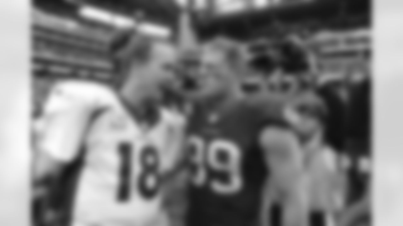 Denver Broncos quarterback Peyton Manning (18) greets Houston Texans J.J. Watt (99) at midfield after Denver defeated Houston 37-13 in the NFL game in Houston TX December 22, 2013.