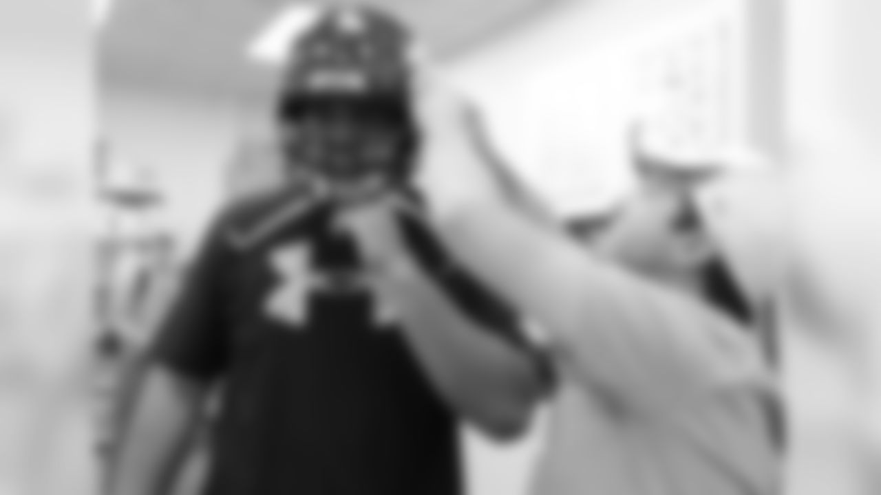 The guard from Kansas State gets fit for a helmet.