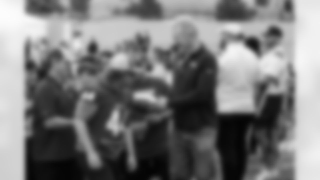 The Eaton High School 2A 2020 football state championship team receives a commemorative football from Karl Mecklenburg at the Back Together Saturday event celebrating the return of fans to training camp at UCHealth Training Center on July 31, 2021. (Photo by Ben Swanson)