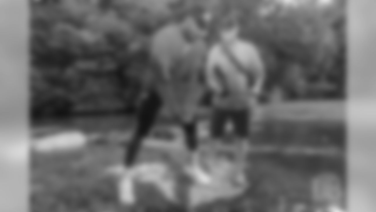 Von Miller picks up his catch at the fishing portion of Von Miller's Pass Rush Summit at Dogwood Canyon Nature Park on June 28, 2018.