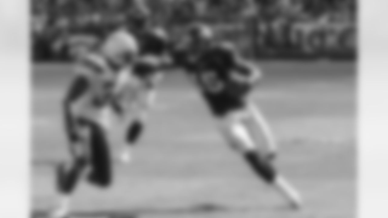 Brandon Marshall applies a stiff arm to a Chargers defender.