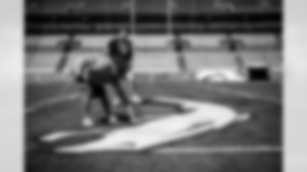 Members of the stadium's turf crew paint the field at Empower Field at Mile High on September 23, 2021 ahead of the team's Week 3 home opener. (Photo by Ben Swanson)
