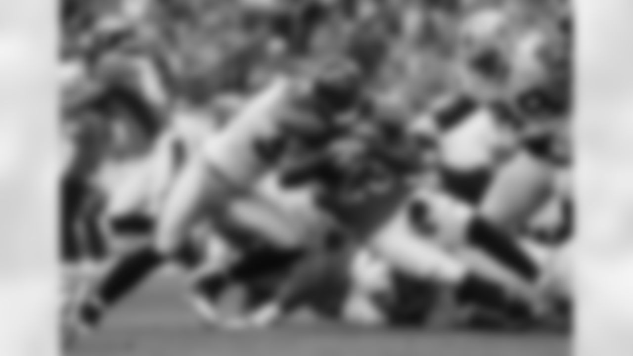 RB Willis McGahee pushes forward during the first half against the Oakland Raiders.