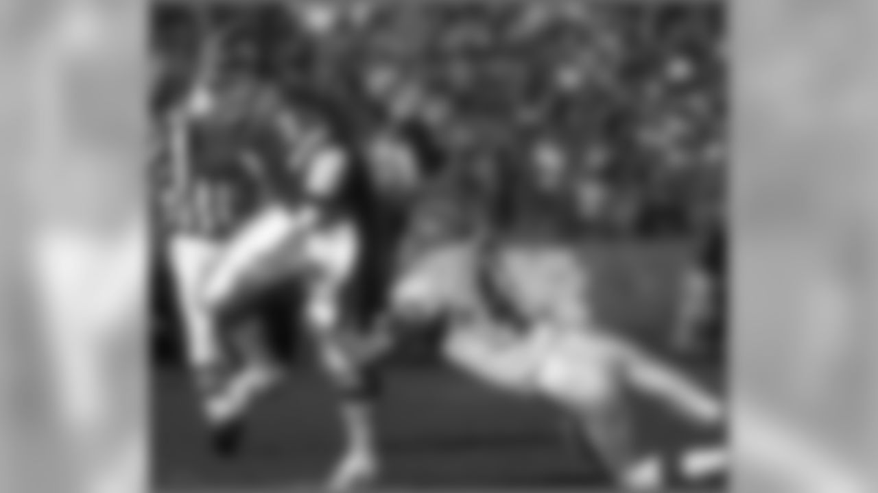 Elway's mobility helped avoid many would-be tacklers, like this one in the 1989 AFC Championship Game.